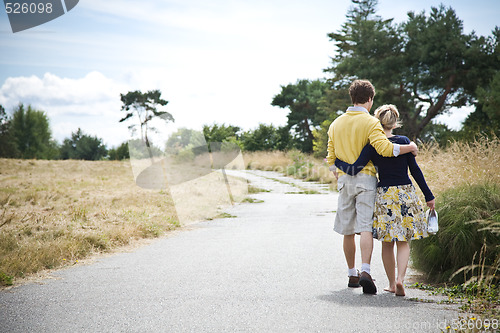 Image of Young caucasian couple walking in a park