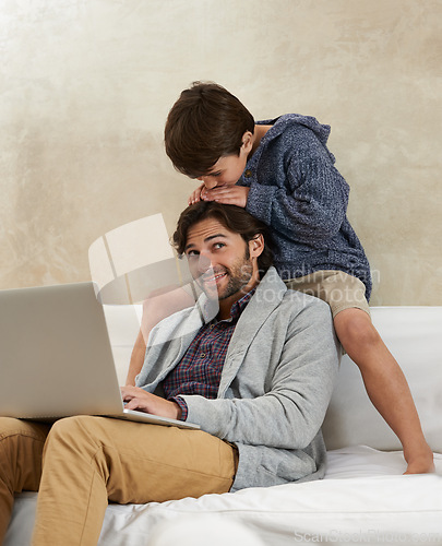 Image of Father, son and laptop on sofa with love, playing and happiness for bonding in living room of home. Family, man and child with remote work, smile and relax on couch in lounge of house with trust