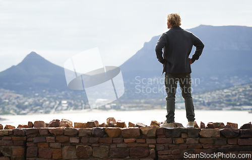 Image of Man, watching mountains and thinking of adventure ideas and inspiration in Cape Town, South Africa. Male person and natural scenery for contemplating, planning and explore on wall with mock up