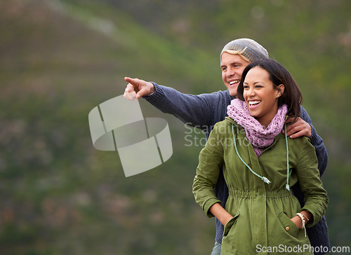 Image of Happy couple, pointing and nature in adventure for sightseeing, journey or outdoor view together. Man and woman with smile enjoying holiday, vacation or getaway in natural environment on mockup