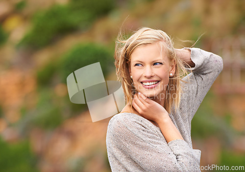 Image of Woman, nature and wind for outdoor travel on holiday vacation with smile for adventure, journey or summer. Female person, happy and breeze in California park for explore outside, paradise or freedom
