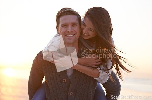 Image of Portrait, piggy back and couple at ocean at sunset for tropical holiday adventure, relax and bonding outdoor. Love, happy man and woman on romantic date with beach, evening sky and vacation together