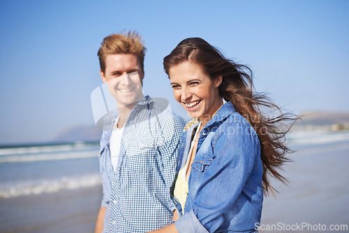 Image of Couple, laugh and walk on beach for romantic date on sunny afternoon with blue sky in Australia. Big smile, man and woman in love for sweet relationship, fun dating and bonding together in summer