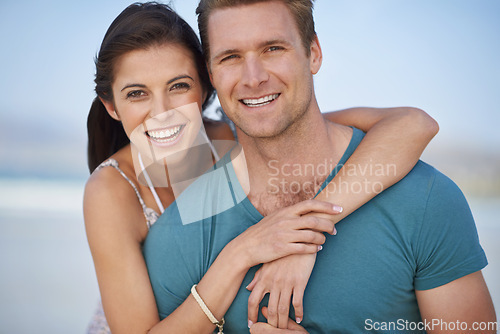 Image of Portrait, couple and smile for embrace, seaside and fun date on sunny afternoon in Portugal. Hug, man and woman in love for sweet relationship, romance and bonding together on weekend getaway