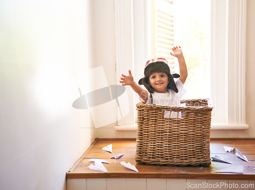 Image of Flying, paper plane and child playing with adventure, imagination and fun in basket at home. Fantasy, little pilot and playful boy in box with future dream, growth and development with airplane