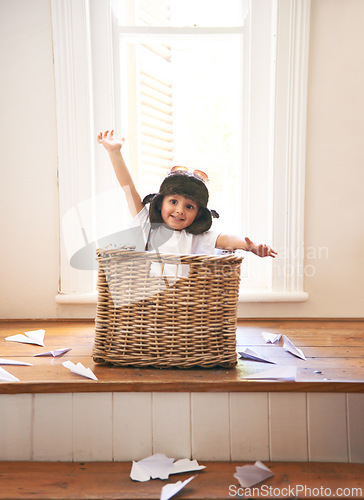 Image of Flying, playing and child with paper plane fantasy and imagination with fun in basket in home. Adventure, little pilot and playful boy in box with future dream, growth and development with airplane