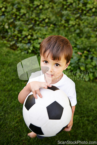 Image of Portrait, boy or play with soccer ball in park for fun, healthy or childhood development in Morocco. Happy, young and male child with football for afternoon game or exercise in backyard or garden