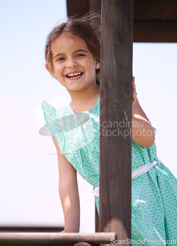 Image of Portrait, smile and child at playground outdoor in summer for fun on vacation with cute, adorable and innocent girl. Playing, happy and kid at jungle gym, funny and laughing for joy alone in Spain