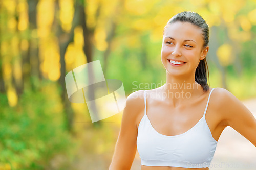 Image of Thinking, fitness and woman outdoor with happiness in woods or forest and idea for exercise. Planning, workout and runner smile in summer, nature or girl in park with pride and healthy mindset