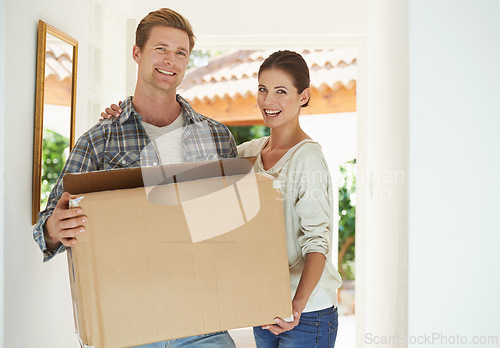 Image of New home, portrait or happy couple with box for moving or excited for investment in real estate. Man, woman and proud homeowner with package by front door and smile face in living room for mortgage