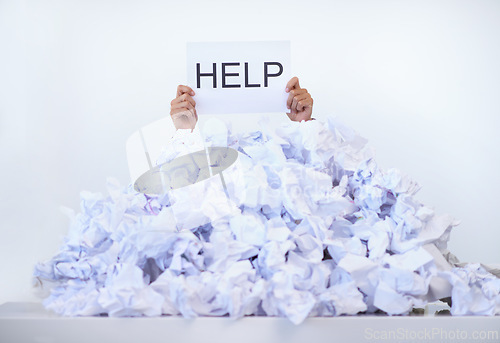 Image of Person, office and hands with pile of paperwork, sign and help with burnout, stress and administration. Debt, bills and worker lost in documents, overworked and overwhelmed with pressure at desk.
