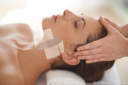 Image of Hands, head massage and woman at spa to relax, wellness and calm at luxury resort for therapy with masseuse for health. Closeup, face and person at salon for facial treatment, skincare and beauty