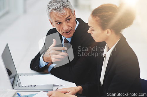 Image of Boss, laptop and meeting with employee in office with brainstorming in corporate company. Woman, serious and listening to CEO of business, professional and notebook for planning on desk in workplace