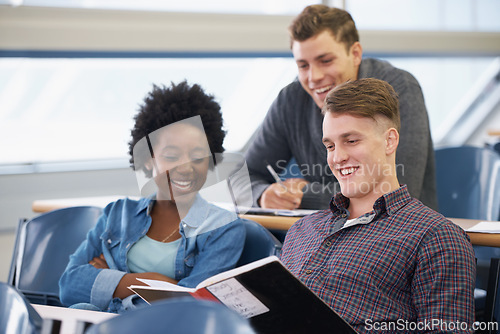 Image of Student, studying and friends in a classroom with learning, education and university with smile. Book, college and test with notebook, lecture and group with diversity and young people at school