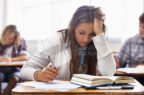 Image of University, classroom and woman with stress for exam, education and opportunity. College, learning and tired student with book, fatigue and anxiety for test, assessment or studying report with notes.