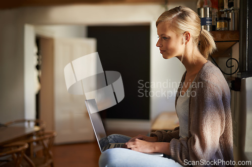 Image of Remote work, laptop and woman reading in a house for research, planning or web communication. Freelance, typing and female person in living room with online editing, writing or checking social media