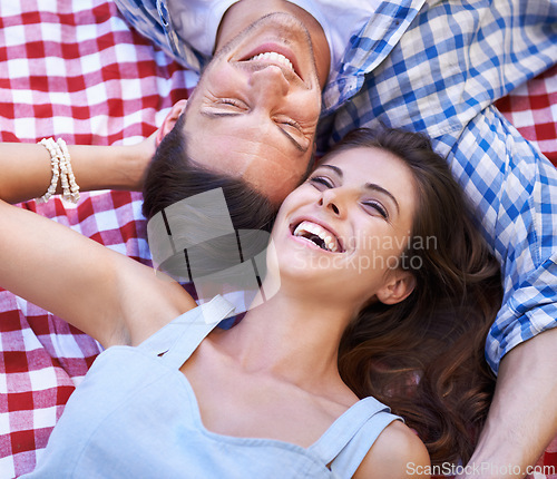 Image of Relax, love and happy with couple and picnic in park for romance, valentines day and date together. Smile, calm and vacation with man and woman laughing on blanket for summer, bonding and peace