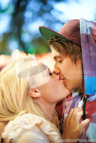 Image of Couple, kiss and outdoor for festival, love and hug with romantic connection in nature at party. Woman, man and together with embrace for celebration on date with bonding, care and lips in California