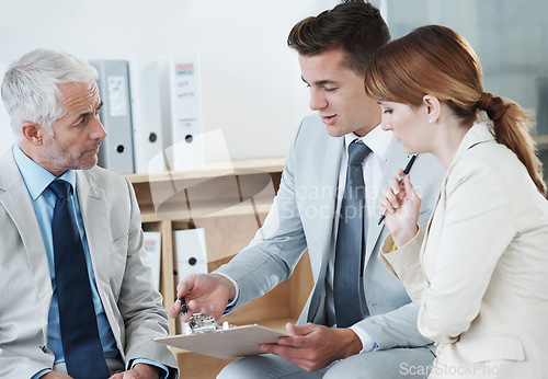 Image of Business people, lawyer or reading a contract for collaboration, strategy or notes at office. Group, teamwork or employees with documents, deal or paperwork in meeting for brainstorming at workplace