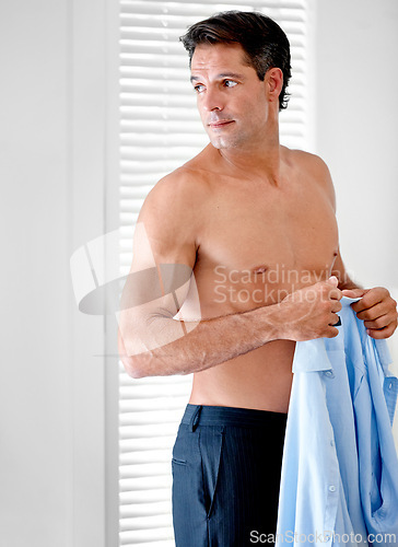 Image of Morning, man and getting ready for work in bedroom at home. Corporate, professional and business style with confident employee dressing for the start of career day, suit and formal attire closeup