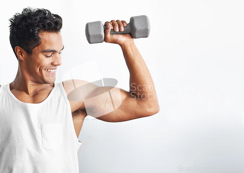 Image of Fitness, gym and happy man with dumbbell in studio for weightlifting, sports or mockup on white background. Training, face or male bodybuilder with space for power, performance or bicep challenge