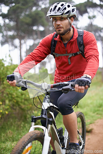 Image of Fitness, mountain bike and man cycling in countryside for adventure, discovery or off road sports hobby. Exercise, health and young cyclist with helmet on bicycle in nature for training or workout