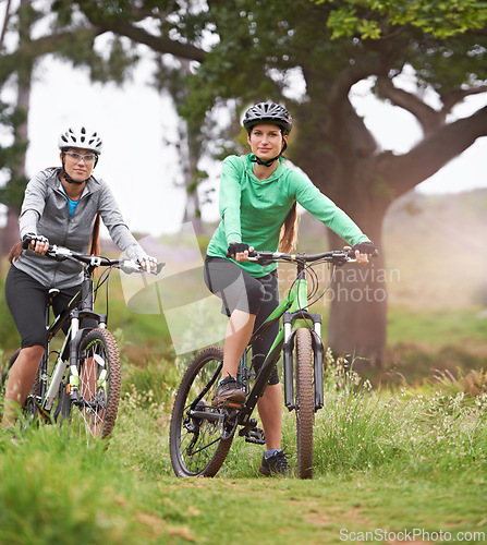 Image of Happy woman, portrait and friends with bicycle on field for sports, fitness or outdoor cycling in nature. Female person, athlete or cyclist in forest for off road workout, training or cardio exercise