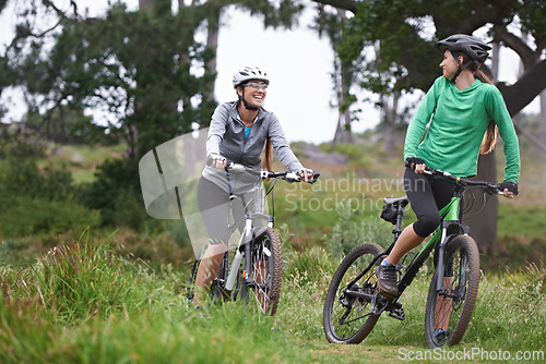 Image of Happy woman, friends and fitness with bicycle on field for outdoor cycling, workout or cardio exercise in nature. Female person, athlete or cyclist with smile in forest for off road training on trail