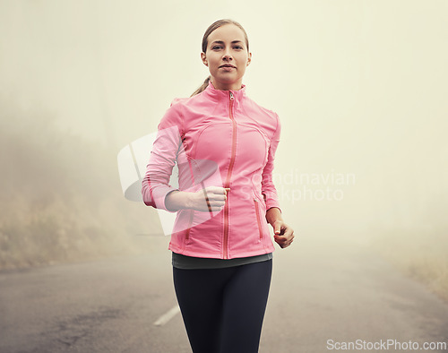 Image of Nature, fitness and portrait of woman running on mountain road for race, marathon or competition training. Sports, exercise and female athlete with cardio workout in misty outdoor woods or forest.