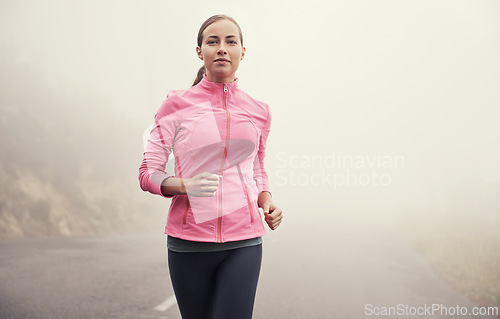 Image of Nature, sports and portrait of woman running on mountain road for race, marathon or competition training. Fitness, exercise and female athlete with cardio workout in misty outdoor woods or forest.