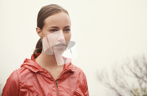 Image of Woman, face and fitness in nature with fog for hiking, exercise and workout outdoor with confidence. Athlete, person and mockup space with pride for running, training and sportswear for healthy body