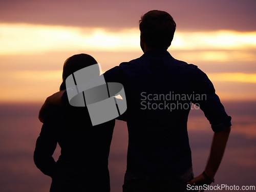 Image of Back, sunset and couple hug with silhouette, view outdoor with nature and travel together for love and bonding. Adventure, journey and people in environment, orange sky with support and trust