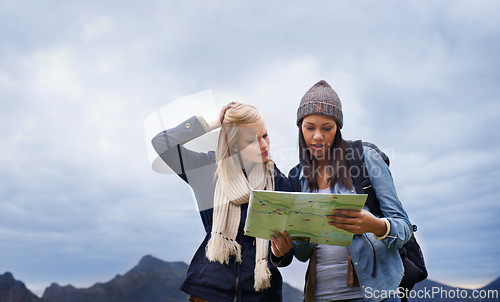 Image of Woman, friends and thinking with map for direction or location on hiking adventure together in nature. Young female person, hiker or team lost with travel guide for destination, route or outdoor path