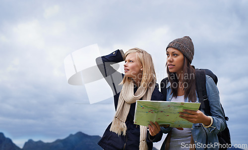 Image of Woman, friends and thinking with map for lost direction, location or hiking adventure together in nature. Young female person, hiker or team with travel guide for destination, route or outdoor path