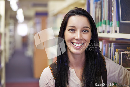 Image of Smile, student and portrait of woman in library for studying at university for test, exam or assignment. Happy, education and confident young female person by books at college campus or academy.