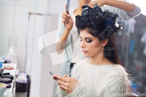 Image of Model, woman and phone with hairdresser for beauty, hair stylist and behind the scenes with social media search. Salon, beautician and person with smartphone for internet scroll while getting ready