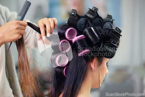 Image of Woman, hair care and makeup with curlers and hands of stylist, cosmetic care and beautician with treatment. Beauty in salon, actor or celebrity backstage with hairdresser and styling for glamour