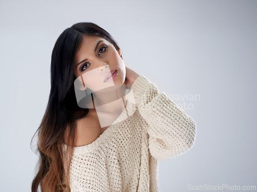 Image of Woman, fashion and hair, portrait and makeup in studio for winter style salon with treatment and wellness on white background. Cosmetics, trendy jersey or sweater with haircare, volume and growth