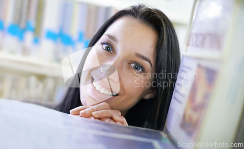 Image of Happy, student and portrait of woman in library for studying at university for test, exam or assignment. Smile, education and confident young female person by books at college campus or academy.