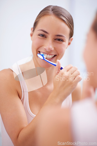 Image of Portrait, smile and toothbrush for oral hygiene care with woman in bathroom of home for teeth whitening. Face, dental care and happy young person in apartment to prevent tooth decay or gum disease