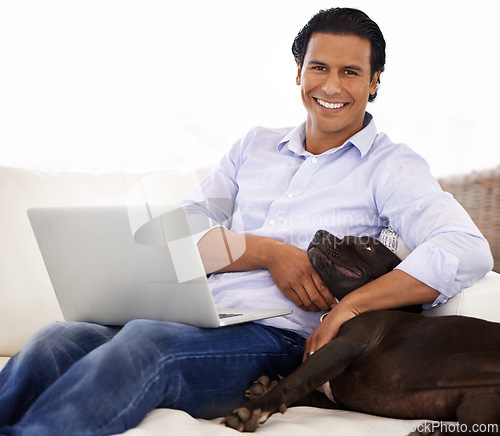 Image of Man, dog and portrait with laptop on sofa for bonding, playing or happiness with remote work in home. Animal, person and face with smile on couch in living room for research, cuddle or love for puppy
