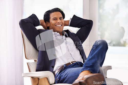 Image of Relax, stretching and businessman portrait on chair smile, relieved or work success satisfaction at home. Happy, face and male entrepreneur in a living room relax, chilling or moment of stress relief