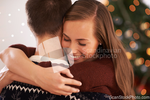 Image of Home, hug and couple with Christmas, celebration and festive season with marriage or holiday. Apartment, embrace or man with woman or vacation with Xmas or happy with relationship or bonding together