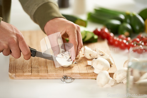 Image of Vegetables, cooking and hands cutting mushroom on kitchen counter with salad, wellness and nutrition in home. Wood board, knife and healthy food with brunch, chef and vegan meal prep in apartment