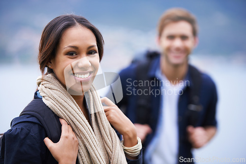 Image of Hiking, couple and portrait of woman on mountain with backpack for freedom, trekking and explore. Travel, dating and man and female with ocean scenic view on holiday, vacation and outdoor adventure