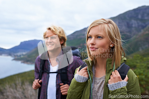 Image of Happy couple, hiking and backpack on mountain for sightseeing, travel or outdoor journey in nature. Face of young man, woman or hikers carrying bag on back for trekking, fitness or adventure in woods