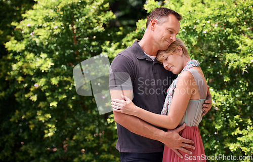 Image of Love, hug and couple in nature with support, commitment and trust, care and solidarity while bonding in a park. Safety, security and people embrace in a garden with peace, calm or soulmate connection
