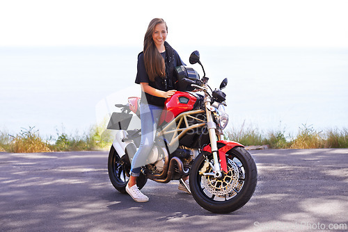 Image of Happy woman, rider and motorcycle by the ocean for road trip, travel or outdoor holiday in nature. Female person or biker with smile on hot ride or bike with helmet for transport on mockup space