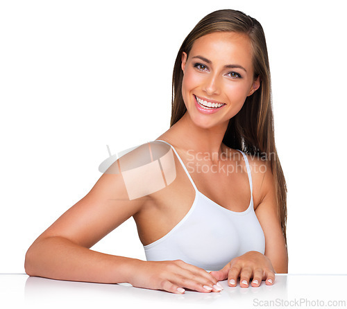 Image of Portrait, skincare and happy woman on table for beauty or dermatology isolated on a white studio background. Face, cosmetics and smile of model on desk in spa for facial makeup, wellness or aesthetic