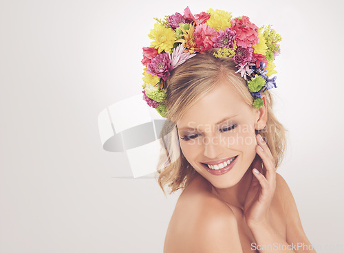 Image of Woman, face and flowers on crown in studio with makeup and happiness for cosmetics, beauty and skincare. Spring aesthetic, model and floral headband with mockup space and wellness on white background